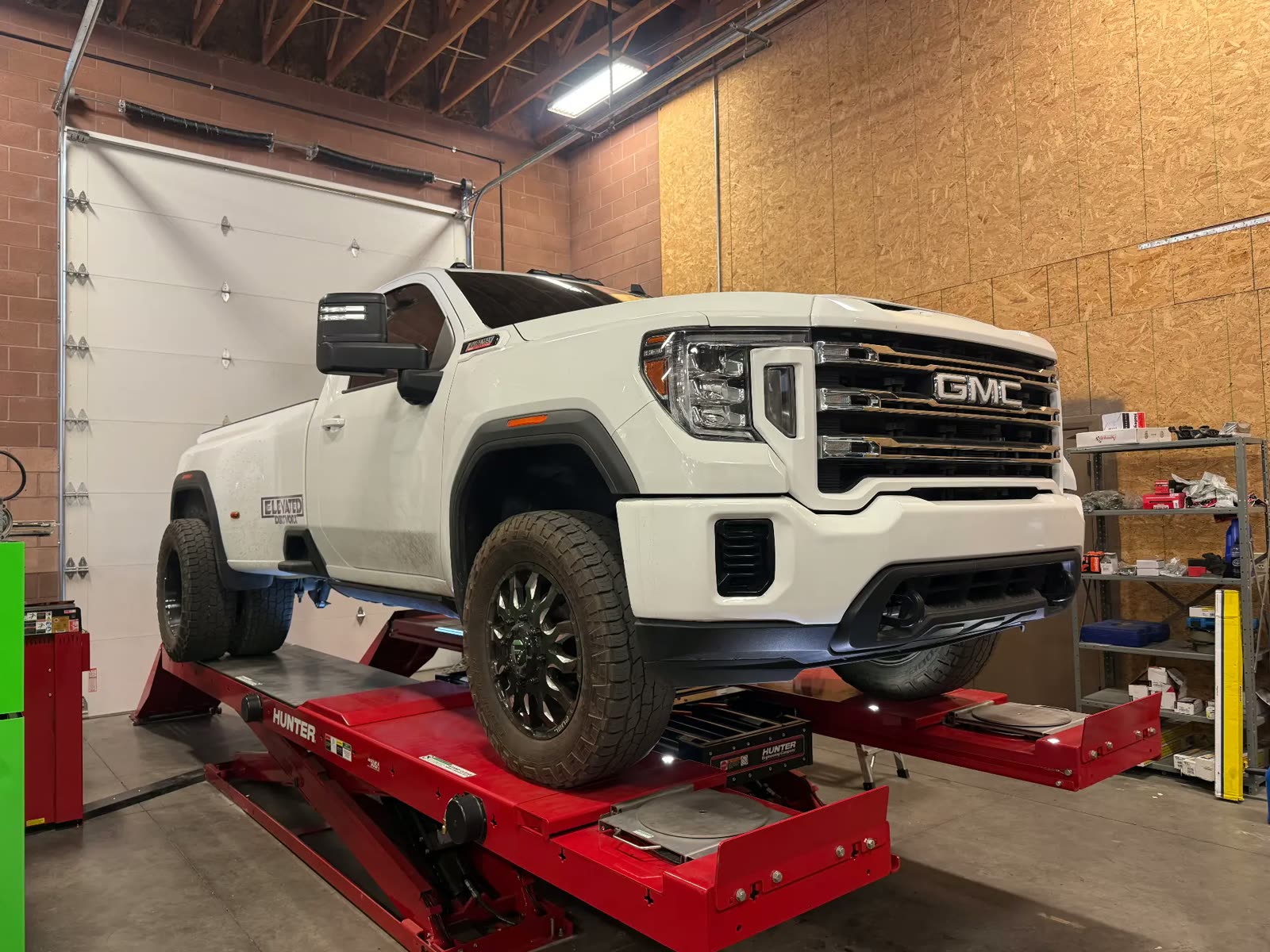White GMC Sierra HD dually on the Hunter alignment rack