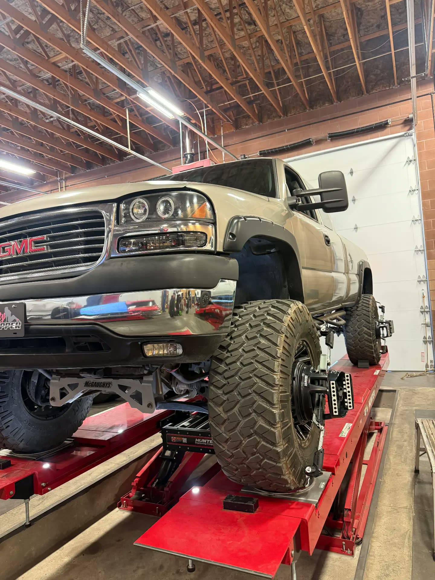 Lifted GMC pickup with alignment heads mounted to the wheels