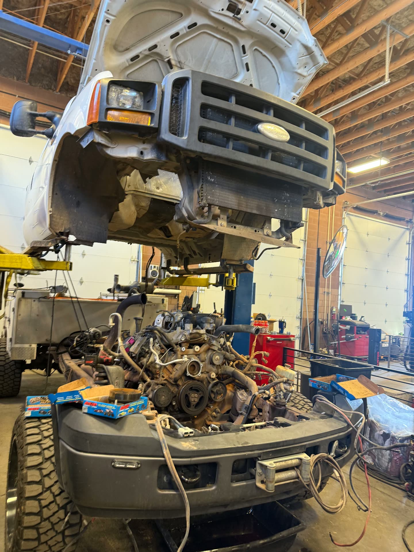 Ford Super Duty with the cab lifted off for engine work in the MPA shop