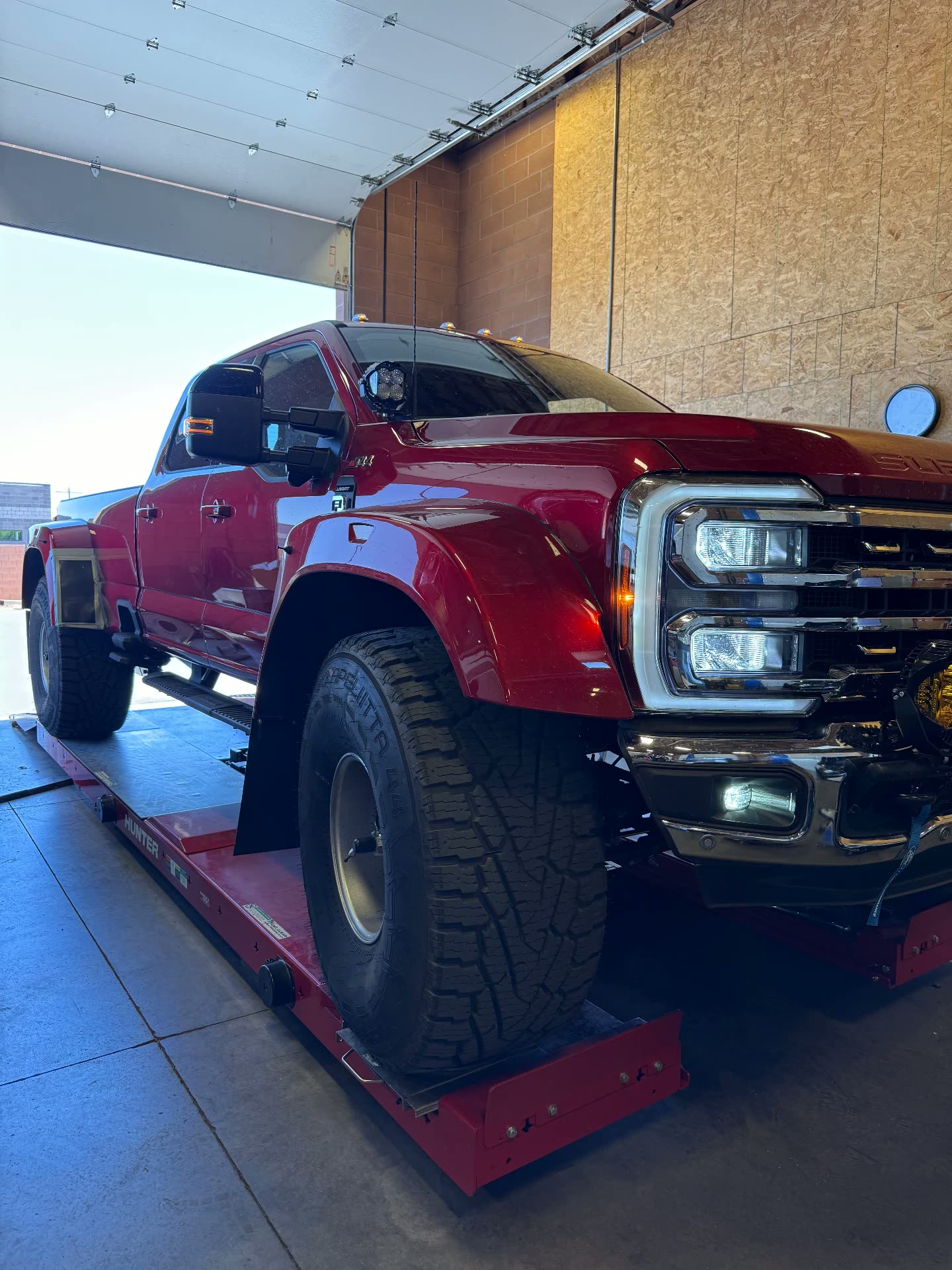 Red Ford Super Duty dually on the Hunter alignment rack at MPA