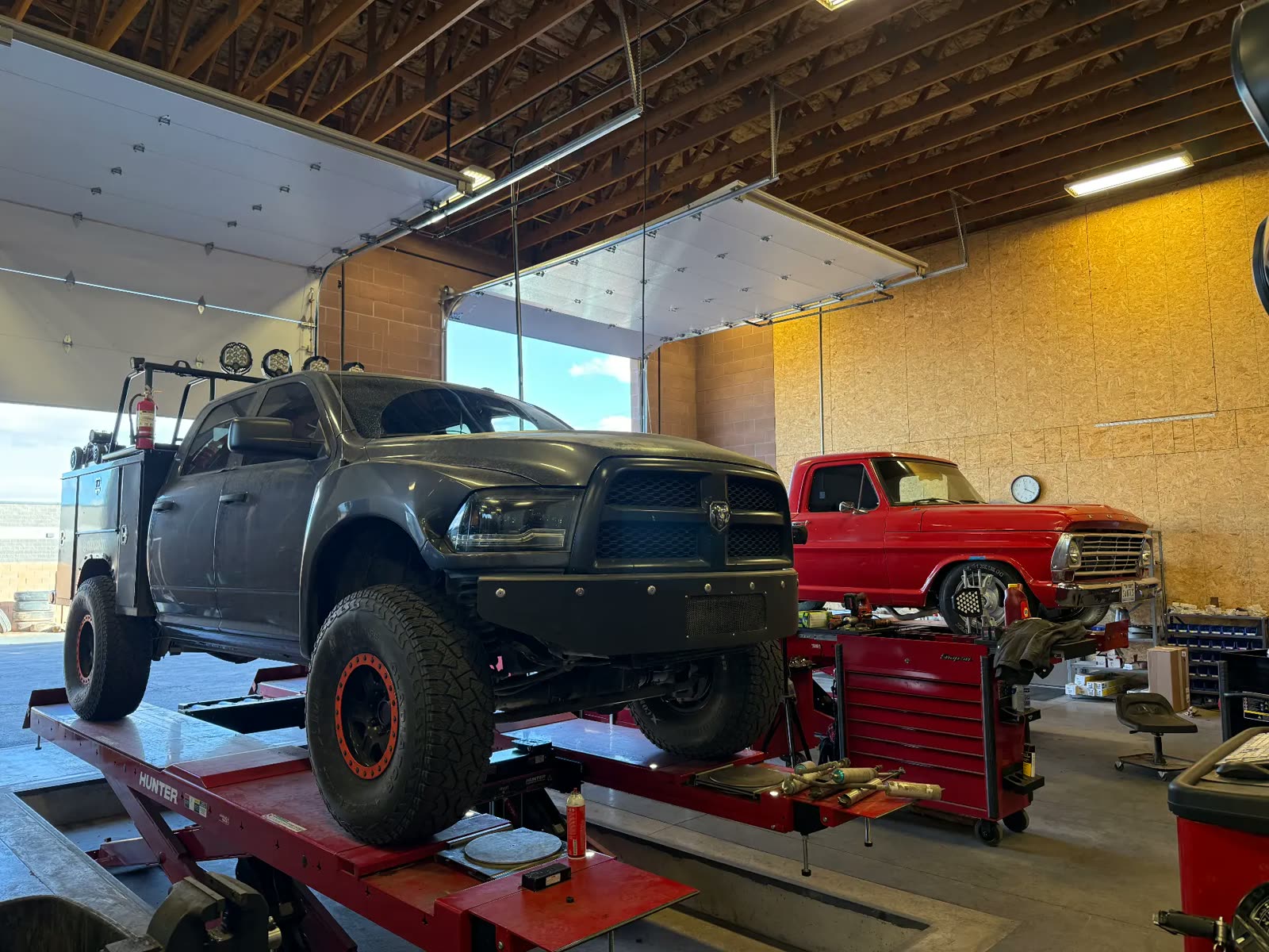 Ram service body truck and a classic Ford pickup in the MPA alignment bays