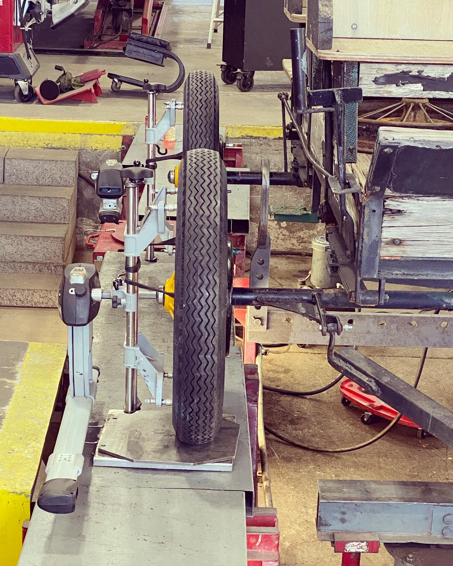 Close-up of alignment sensor heads mounted to an antique wagon wheel