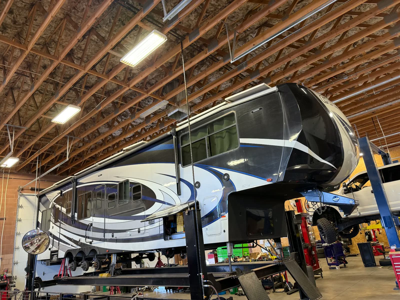 Large fifth wheel travel trailer on the alignment rack