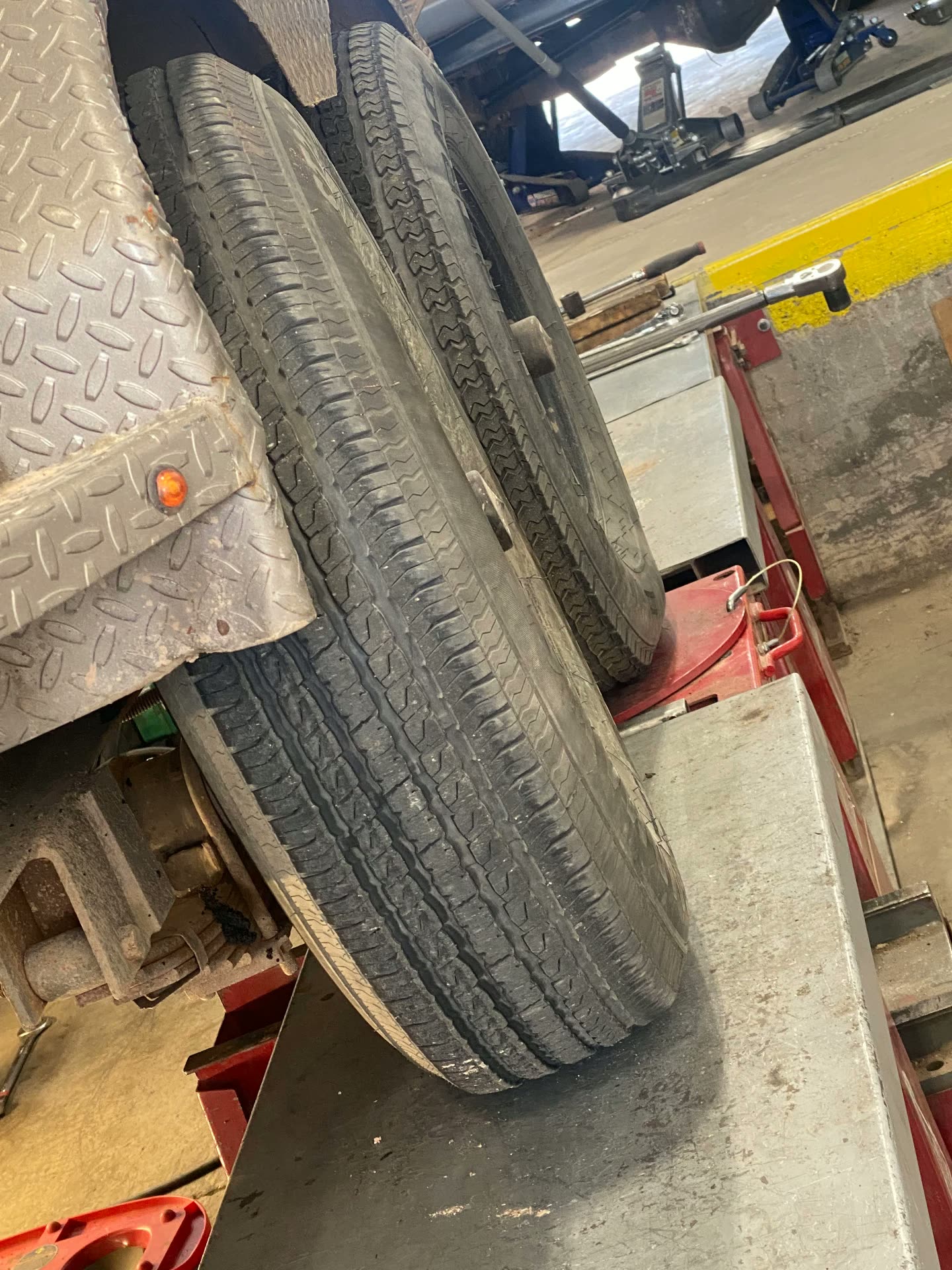 Close look at trailer tire wear during an axle alignment check