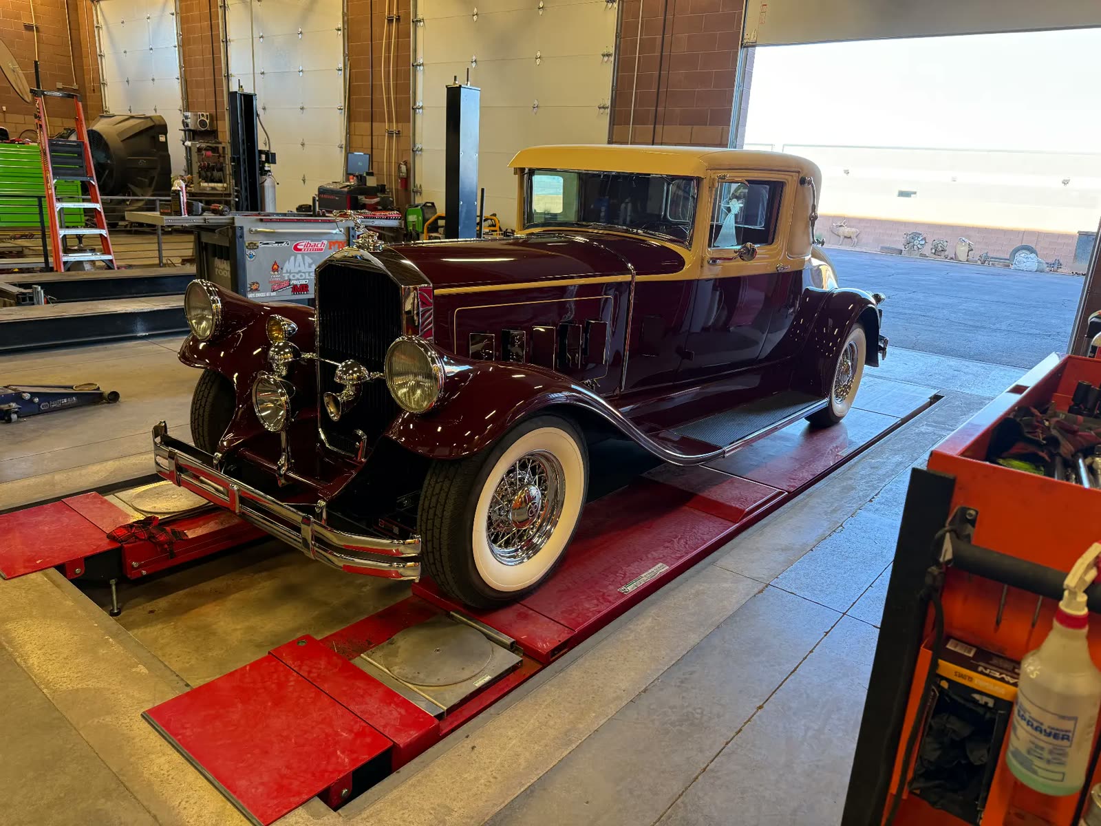 Restored 1930s Packard coupe on the alignment rack at MPA