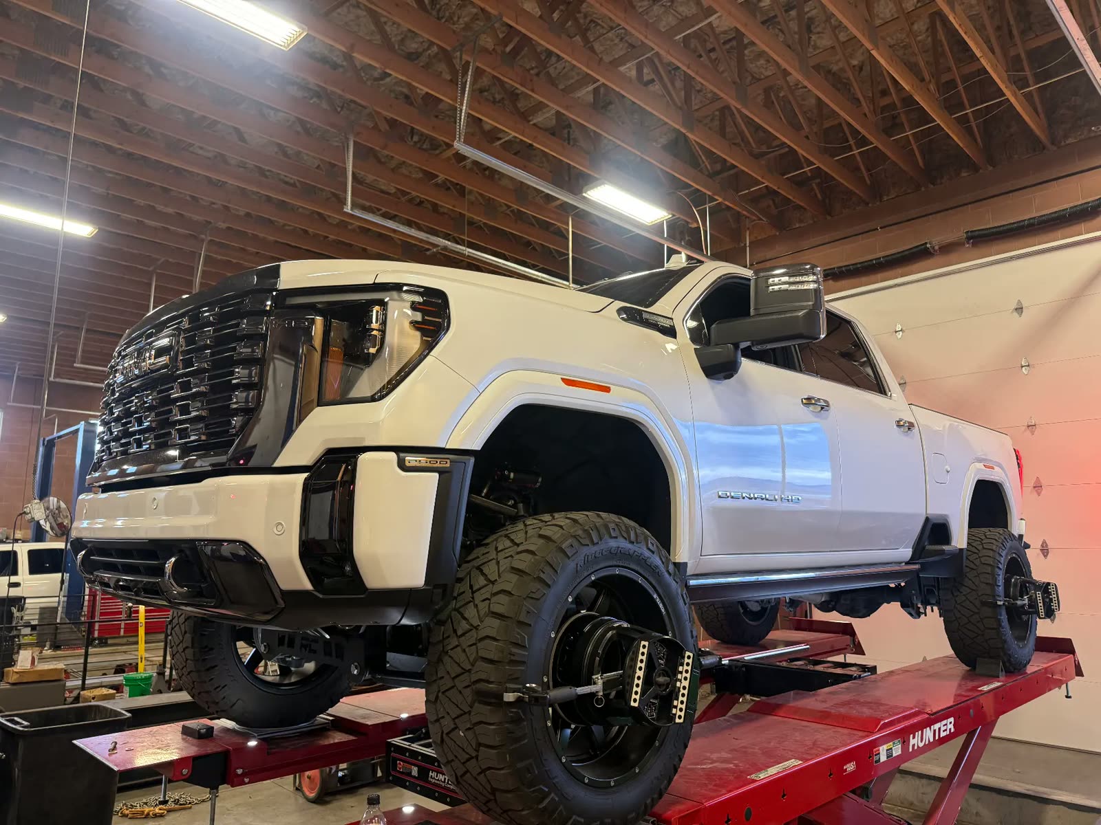 GMC Denali HD 2500 lifted truck on the alignment rack at MPA