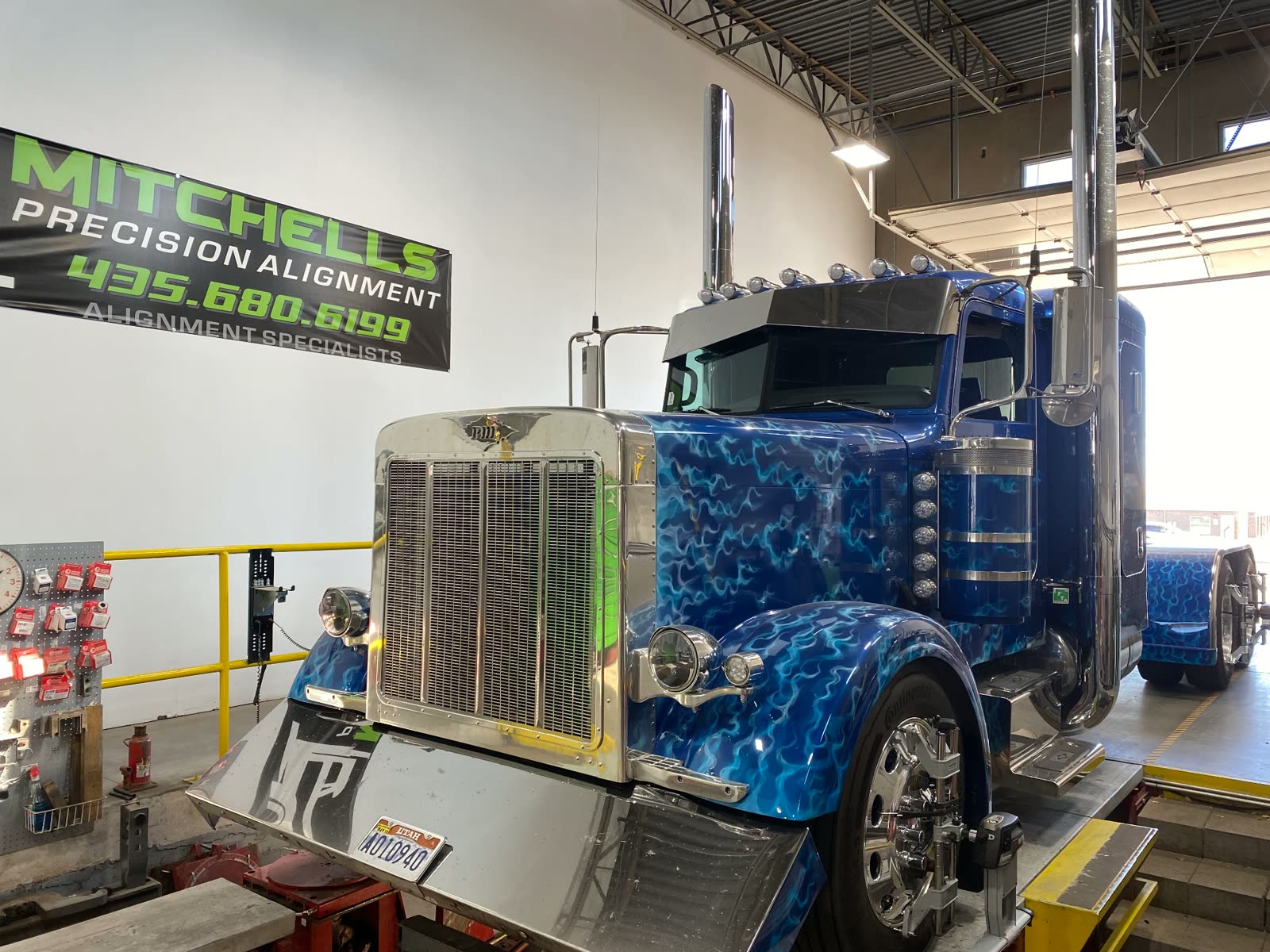 Blue flamed custom Peterbilt getting a steer axle alignment at MPA