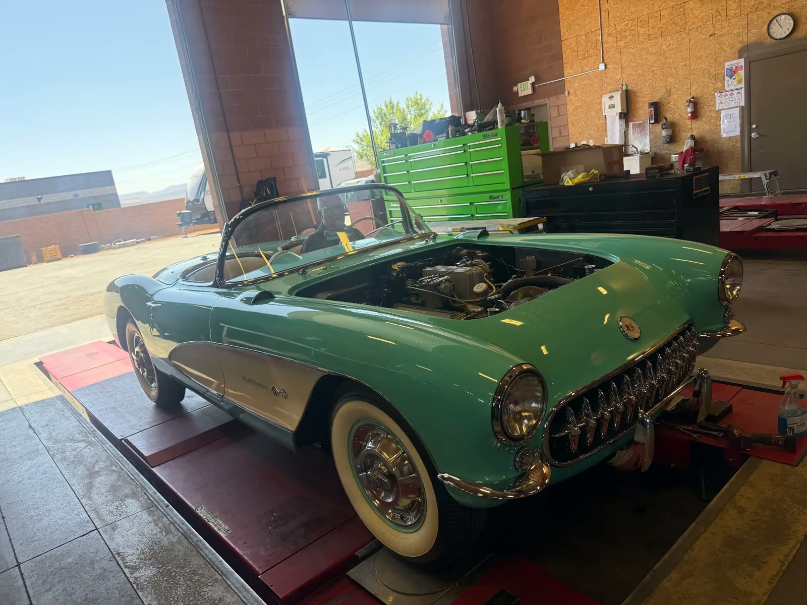 Classic green and white 1957 Corvette on the alignment rack